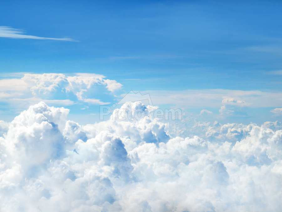 Fluffy white cloud, floating in clear blue sky